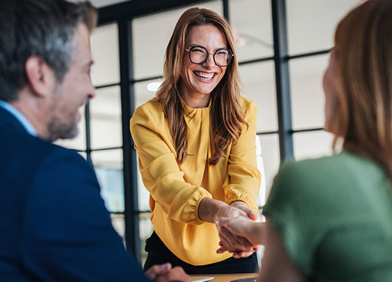 Woman Shaking Hands with Couple