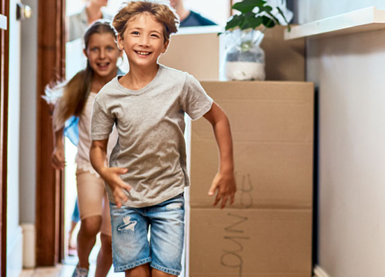 Boy and Girl running into new home