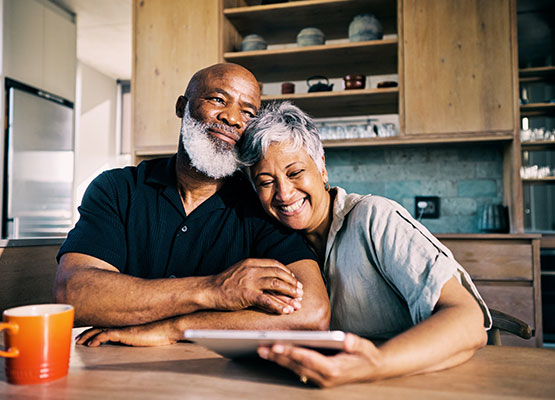 Couple with tablet smiling