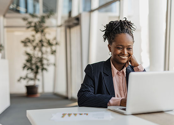 Professional woman on her laptop smiling