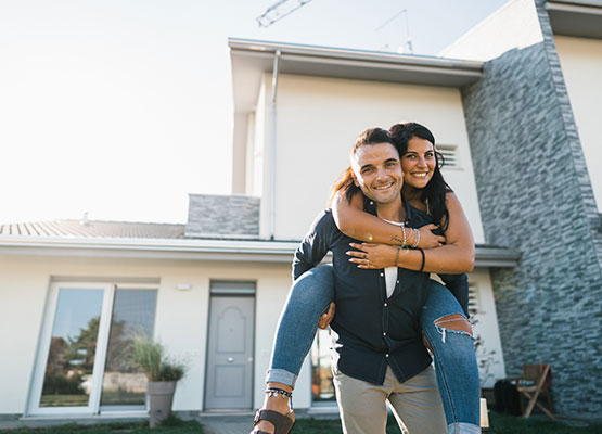 Happy Couple in front of new home