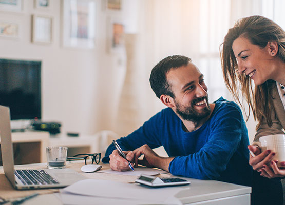 Man and Woman Reviewing Finances Smiling