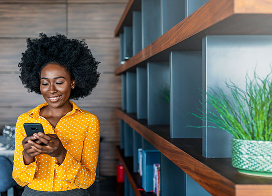 Young woman checking her phone inside a business