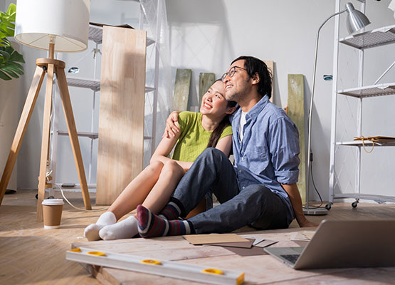 Happy couple sitting on the floor with samples and materials